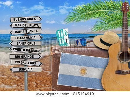 Concept of summer traveling with old suitcase and Argentina town sign