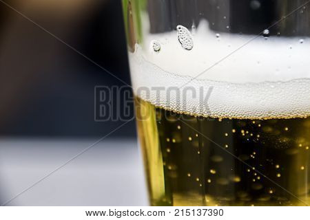 Refreshing Glass Of Beer With Bubbles And Frothy Foam