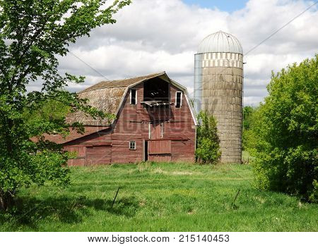 An abandoned barn and silo on a abandoned farmstead.