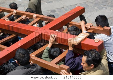 March 25, 2016 San Pedro la Laguna, Guatemala: mayan men carrying a wooden cross during Easter procession