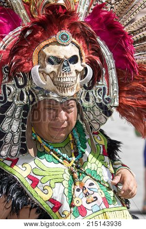March 4, 2016 San Miguel de Allende, Mexico: indigenous man wearing colourful traditional head dress decorated with skull and feathers at the Senior de la Conquista dance celebration