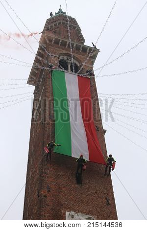 Vicenza, Vi, Italy - December 4, 2015: Firefighters With A Big Italian Flag And The Tower