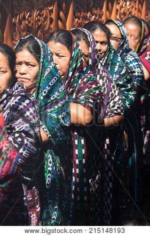 March 25, 2016 San Pedro la Laguna, Guatemala: women float carriers wearing traditional Mayan dress during Easter Week celebration