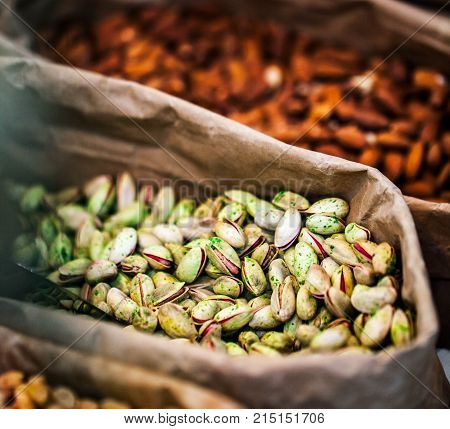 Close-up of Pistachios nuts in paper bags.