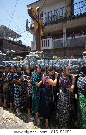 March 25, 2016 San Pedro la Laguna, Guatemala: women float carriers wearing traditional Mayan dress during Easter Week celebration