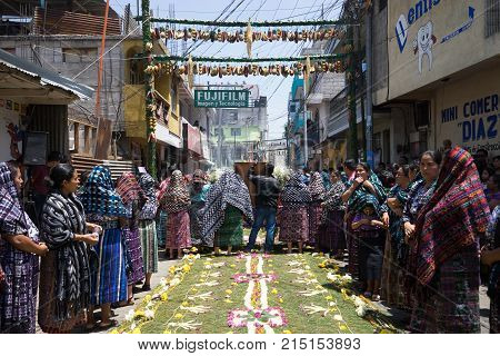 March 24, 2016 San Pedro la Laguna,Guatemala: tzutujil mayan women along the decorated street during Easter celebration