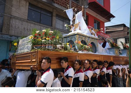 March 25, 2016 San Pedro la Laguna, Guatemala: men carry a heavy religious float during Easter procession