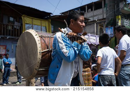 March 24, 2016 San Pedro la Laguna, Guatemala: young mayan man carries a traditional drum on its back during Easter Week celebration