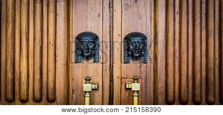 Sphinx Heads Entrance On Wooden Door