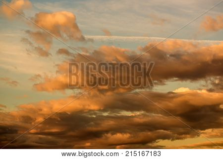 Sunset sky with orange clouds. Beauty in nature. Amazing heaven and cloudscape.