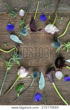 background, interior, nature concept. marvelous flowers with buds of different shapes and colores and cleaned stalks are placed on the wooden table and create circle