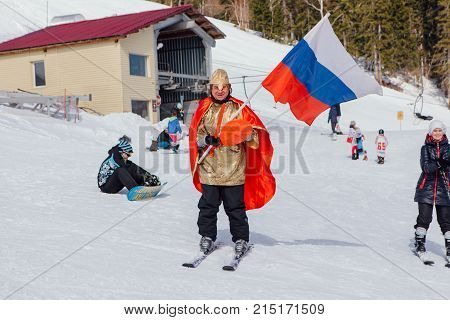 Sheregesh, Kemerovo region, Russia - April 22, 2017: Grelka Fest is a sports and entertainment activity for ski and snowboard riders in carnival costume. Man on ski in carnival costume.