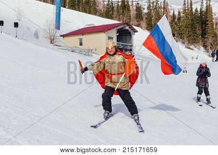 Sheregesh, Kemerovo region, Russia - April 22, 2017: Grelka Fest is a sports and entertainment activity for ski and snowboard riders in carnival costume. Man on ski in carnival costume.