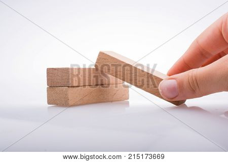 Hand Holding Wooden Domino