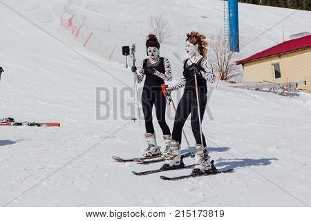 Sheregesh, Kemerovo region, Russia - April 22, 2017: Grelka Fest is a sports and entertainment activity for ski and snowboard riders in carnival costume. Young people in carnival costumes of zebras.
