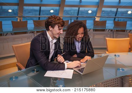 Business people having meeting around table in modern office.