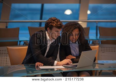 Business people having meeting around table in modern office.