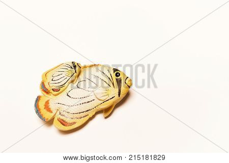 Fish key chain lying on white background.