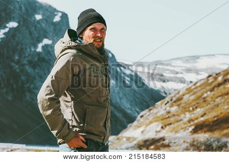 Man traveling in scandinavian mountains Travel lifestyle concept survival into the wild vacations