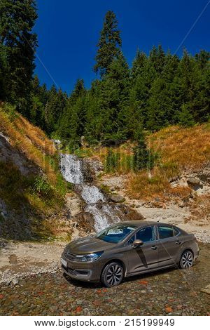 KHULO, GEORGIA - 08 AUGUST 2017: Car in water of the mountain waterfall near Khulo village of Georgian Adjara region
