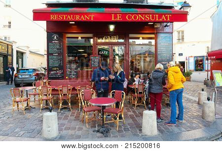 PARIS , France- November 22, 2017: View of typical paris cafe in Paris. Montmartre area is among most popular destinations in Paris, Le Consulat is a typical cafe.