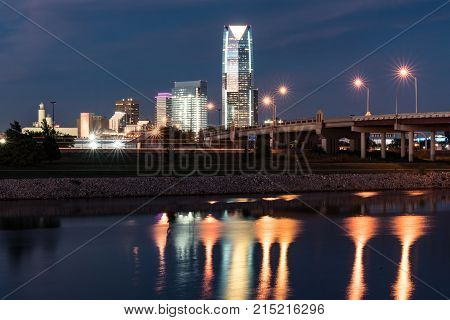OKLAHOMA CITY, OK - OCTOBER 11, 2017: Skyline of Oklahoma City OK at night with reflection in the Oklahoma river