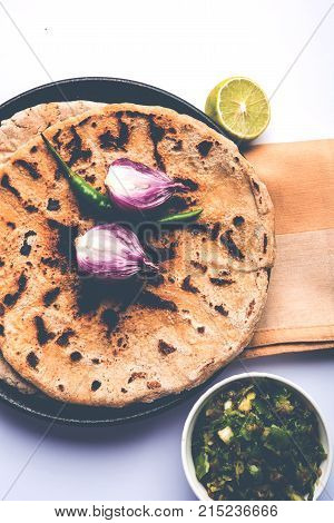Bajra roti or Jowar Roti or Indian bread made using Bajra or Jowar, served with green chilly thecha