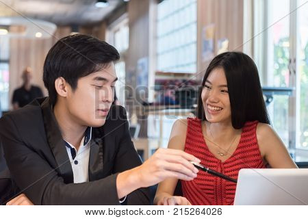 bisuness people discussing with notebook or laptop in office.