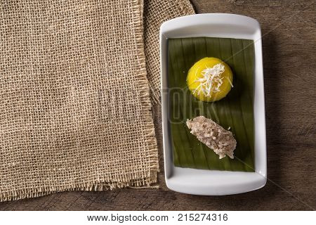 Quindim and vegan coconut, wooden background. Gourmet food.