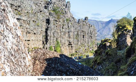 Tourists Between Rocks Of Almannagja Gorge