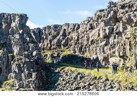 Tourists In Almannagja Gorge In Autumn