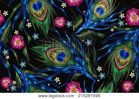 Embroidery peacock feathers and roses flowers seamless pattern. Classical fashionable embroidery beautiful peacocks feathers. Fashionable template for design of clothes. Tails of peacocks vector