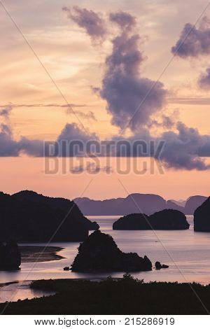 Dramatic cloudy sky before sunrise over dark islands in attractive nature Samet Nangshe Phang Nga of Thailand.
