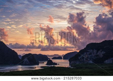 Dramatic cloudy sunrise sky over dark islands in attractive nature Samet Nangshe Phang Nga of Thailand.