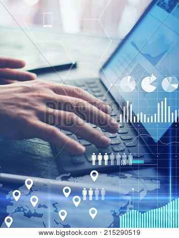 Concept of virtual diagram, graph interfaces, digital display, connections, statistics icons.Man using contemporary electronic tablet with dock keyboard.Blurred background. Vertical