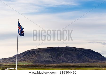 Icelandic Flag And View Of Hill In Iceland