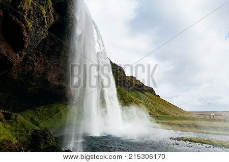 Cave And Seljalandsfoss Waterfall In Iceland