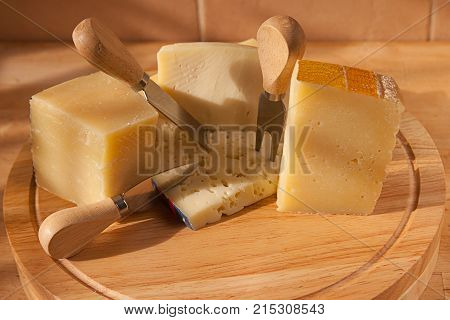 parmigiano, traditional italian cheese platter, with fork and kinfe