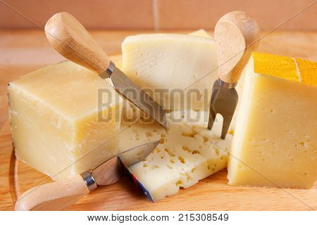 parmigiano, traditional italian cheese platter, with fork and kinfe