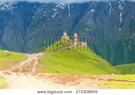 Holy Trinity Church in Georgia. Under Mount Kazbegi. Spring Or Summer Season.