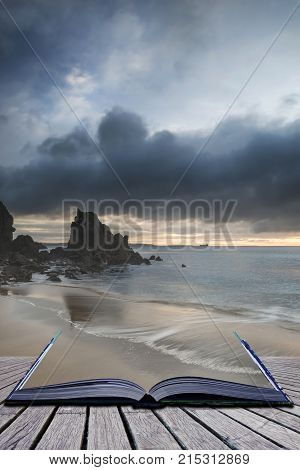 Beautiful sunrise landscape image of Barafundle Bay on Pembrokeshire Coast in Wales in pages of imaginary story book