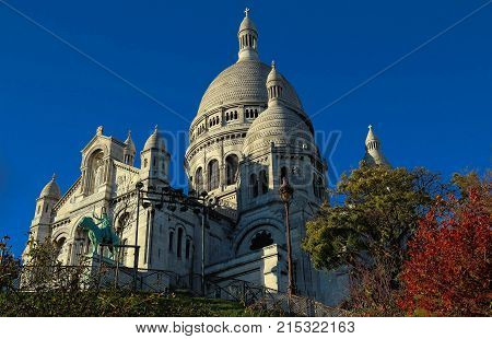 The basilica Sacre Coeur is a Roman catholic church located at the summet of the butte Montmartre , the highest point in Paris.