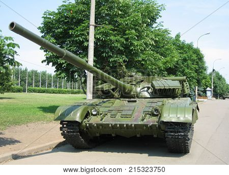 Large Russian green tank against the trees