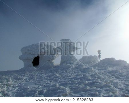 Landscape of the winter Carpathians mountains with refuge on the top