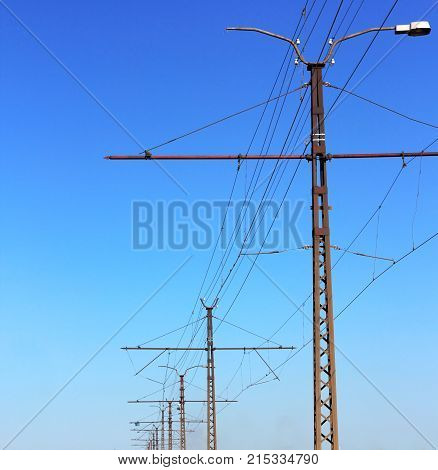 Railroad Railway Catenary Lines Against Clear Blue Sky.