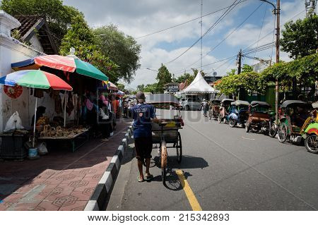 Yogyakarta - October 2017: Traditional rikshaw transport on streets of Yogyakarta, Java, Indonesia. Bicycle rikshaw remains popular means of transport in many Indonesian cities.