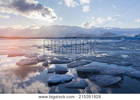 Frozen winter season lagoon with snow mountain natural landscape background Iceland
