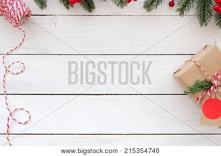 Christmas background - Christmas gift box and decorative elements on white wooden background. Creative flat lay top view design
