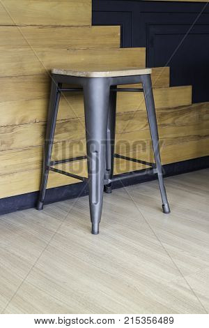 Wood and black metal bar chair on wall background stock photo