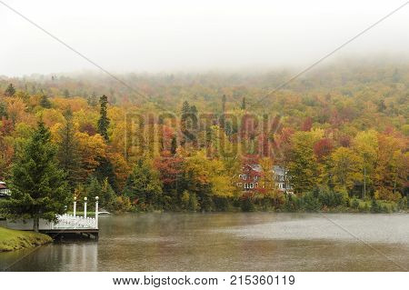 Dixville Notch New Hampshire USA - October 1 2009: Rainy day at The Balsams on Lake Gloriette brings out colors in fall foliage